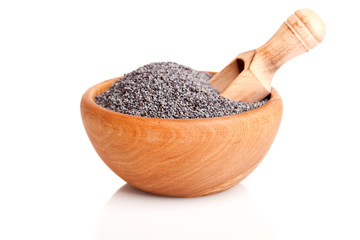 poppyseed in the wooden bowl with spoon, on a white background.