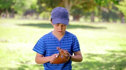 Smiling boy playing with a baseball - Powered by Adobe