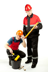 Construction workers in uniform with tools