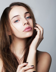 Beautiful young female face with a wellness complexion isolated