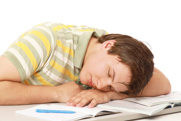 Naklejka premium A young guy sleeping on the desk