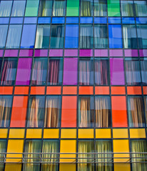 Colorful windows on modern apartment block