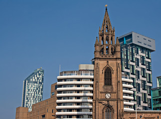 Old church amongst new high rise modern apartments
