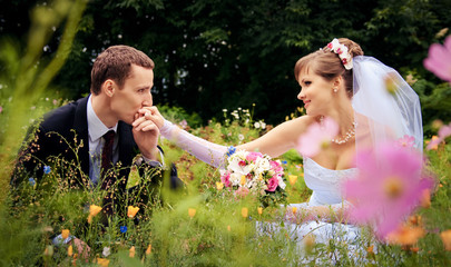The groom kisses the hand of the bride