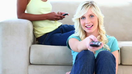 Blonde watching TV on the floor