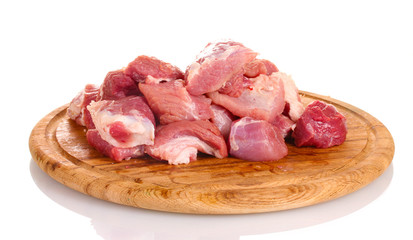 Pieces of raw meat on wooden board isolated on white