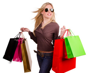 Beautiful blond girl with shopping bags on white