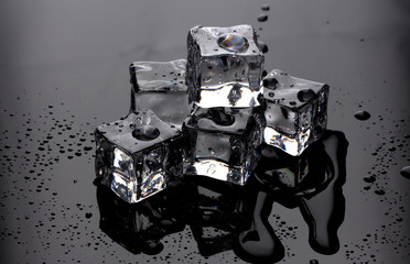 Melting ice cubes on grey background