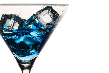 Closeup moving ice cubes in a glass with a blue liqueur