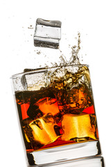 Splash in a glass of whiskey on white background