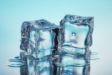 Melting ice cubes on blue background