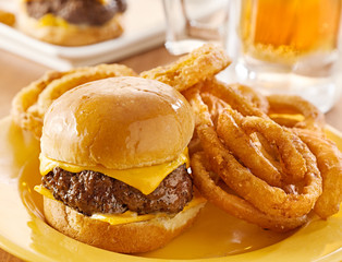 burger slider with onion rings and beer closeup