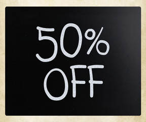 "50% off" handwritten with white chalk on a blackboard