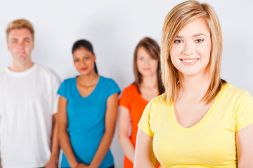happy teen girl standing in front of group of people