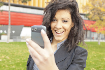 Young Woman with funny hair smile using cell phone walking