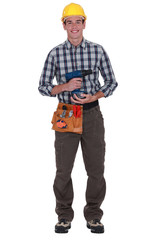 Worker with a cordless drill