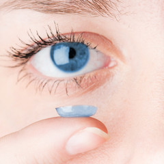 Close up of inserting a contact lens in female eye