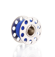 Metal spool of thread isolated on white