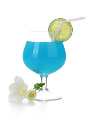 glass of blue cocktail with lime and flowers isolated on white