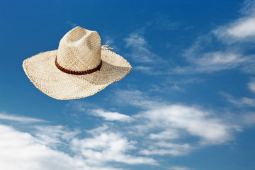 Straw hat flying through the air