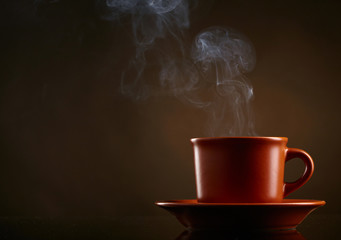 Cup of coffee over dark background