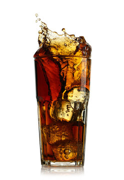 Splashing cola in glass. Isolated on white background