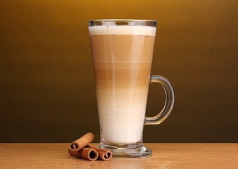 Fragrant сoffee latte in glass cup and cinnamon