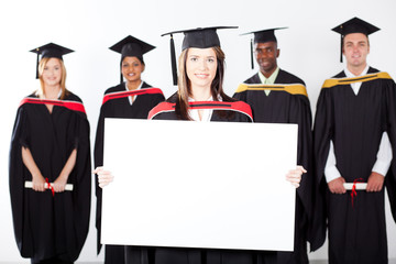 attractive graduate holding white board with classmates
