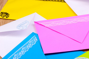 Bunch of color envelopes close-up on wooden background