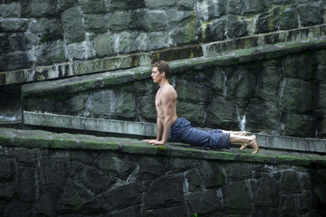 topless man practicing yoga - outdoor