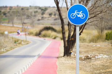 Bicycle lane with white bycicle sign, rural and natural scene