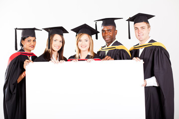 group of graduates with white board