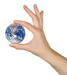 Planet earth on finger.Elements of this image furnished by NASA