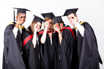 group of graduates looking through their diploma