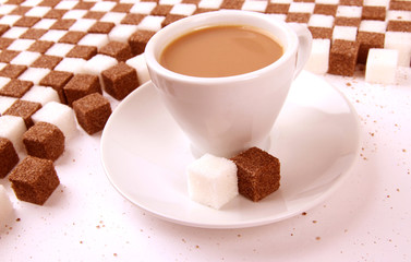 Cup of coffee with sugar on sugared background.