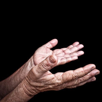 Wrinkled Old Hands Isolated On Black