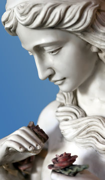 Female Statue Holding A Rose In Hand