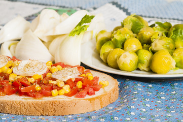 bruschetta with tomato, onion and corn on blue tablecloth