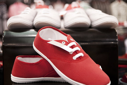 Red sneakers exposed on the shelf.