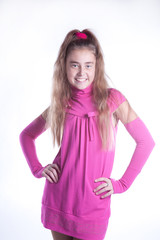 teen girl in a pink dress posing in studio