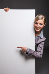 Woman behind white banner on dark gray background