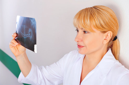 Woman doctor looking at xray results of her patient
