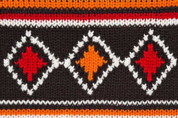 knit sweater  texture. orange, black and white threads. ornament