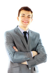 Portrait of a smiling young businessman standing against