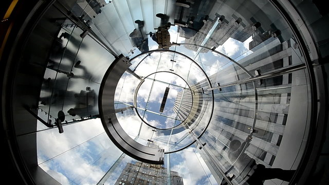 Upward view of People moving on a Modern Circular Staircase