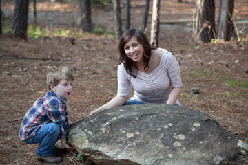 Mother and son outside with a rock