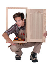 Carpenter with cupboard door