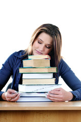 Student sleeping over books at the table