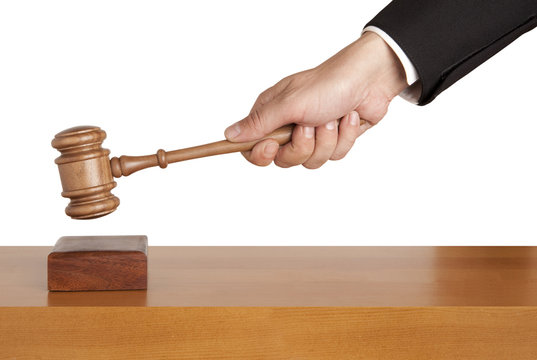 Human Hand Holding A Wooden Gavel