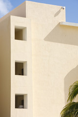 Fototapeta na wymiar Beige Stucco Resort Building with Open Windows